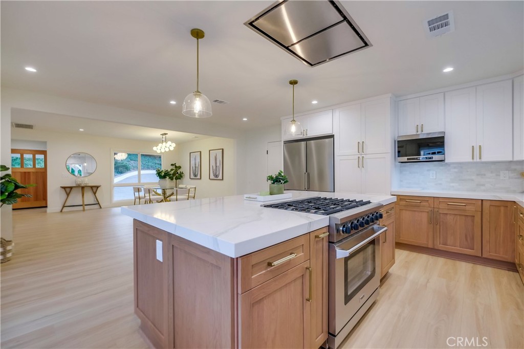 5205 Middlecrest Road Rancho Palos Verdes, CA 90275 - Photo 12 of 63 a kitchen with a stove a sink a refrigerator and chairs