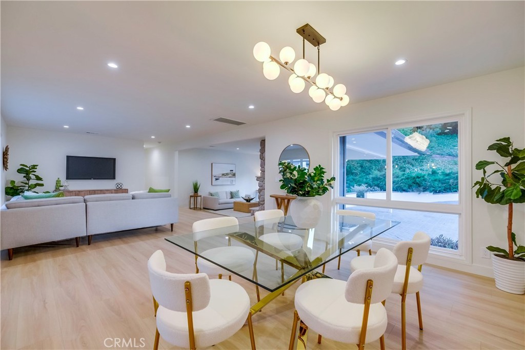 5205 Middlecrest Road Rancho Palos Verdes, CA 90275 - Photo 17 of 63 a view of a dining room with furniture a potted plant and wooden floor