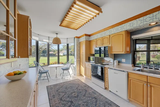 a kitchen with stainless steel appliances granite countertop sink stove top oven and cabinets