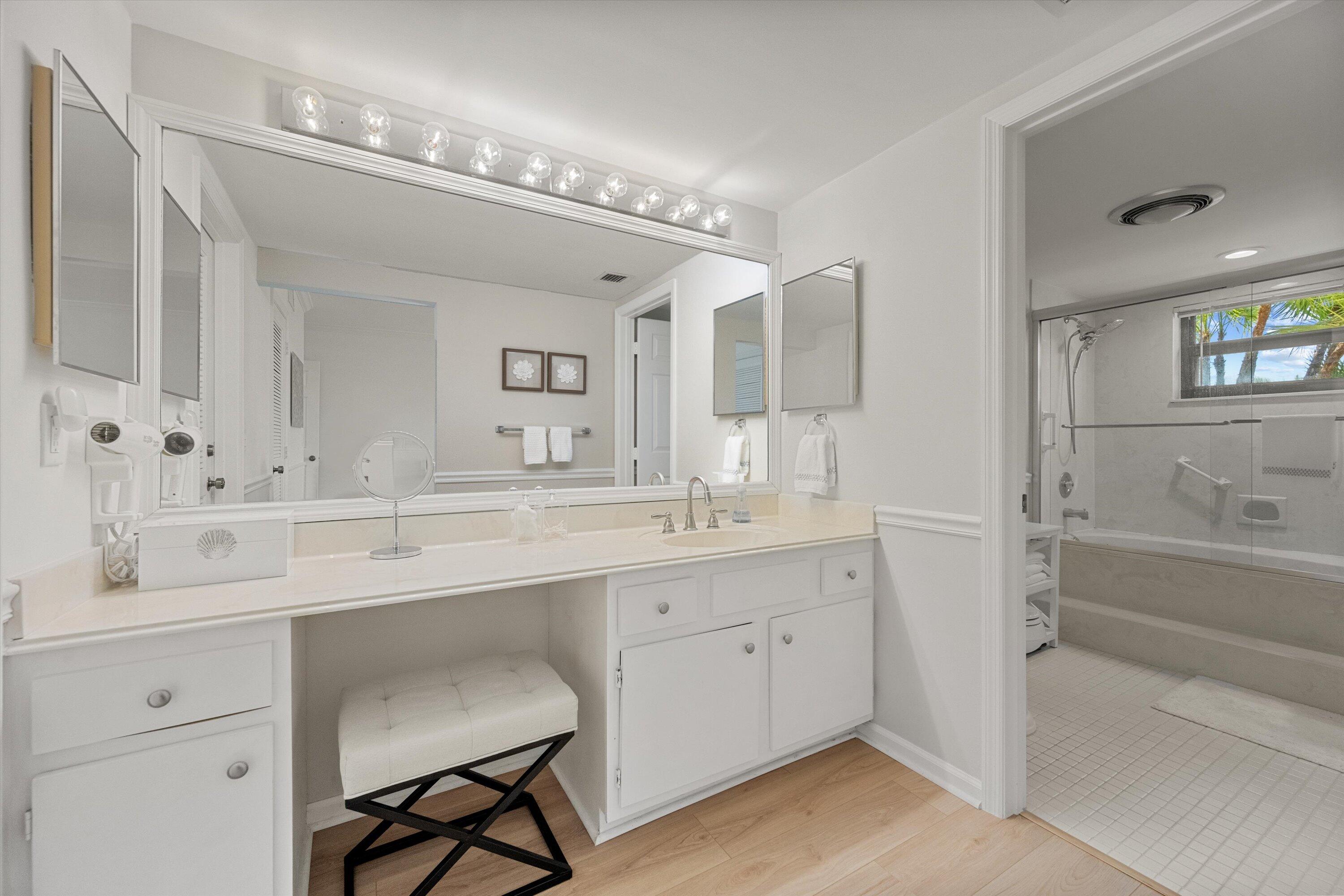 17166 Waterbend Drive, Unit 111 Jupiter, FL 33477 - Photo 18 of 34 a spacious bathroom with a sink double vanity granite tub and a mirror