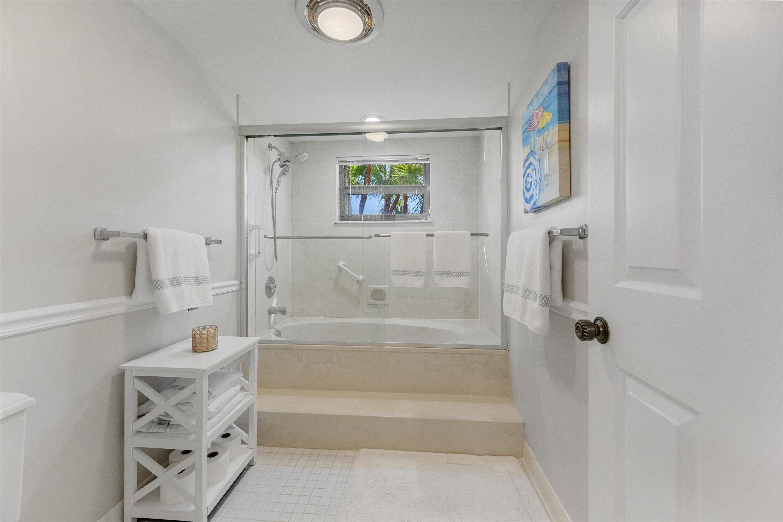 17166 Waterbend Drive, Unit 111 Jupiter, FL 33477 - Photo 19 of 34 a bathroom with a bathtub and a shower