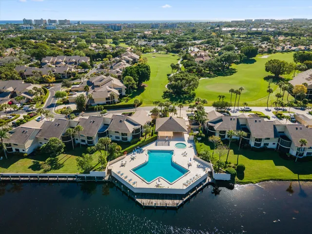 an aerial view of a house with a swimming pool yard and outdoor seating