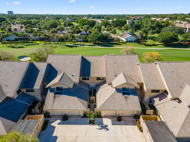 an aerial view of a house with a big yard