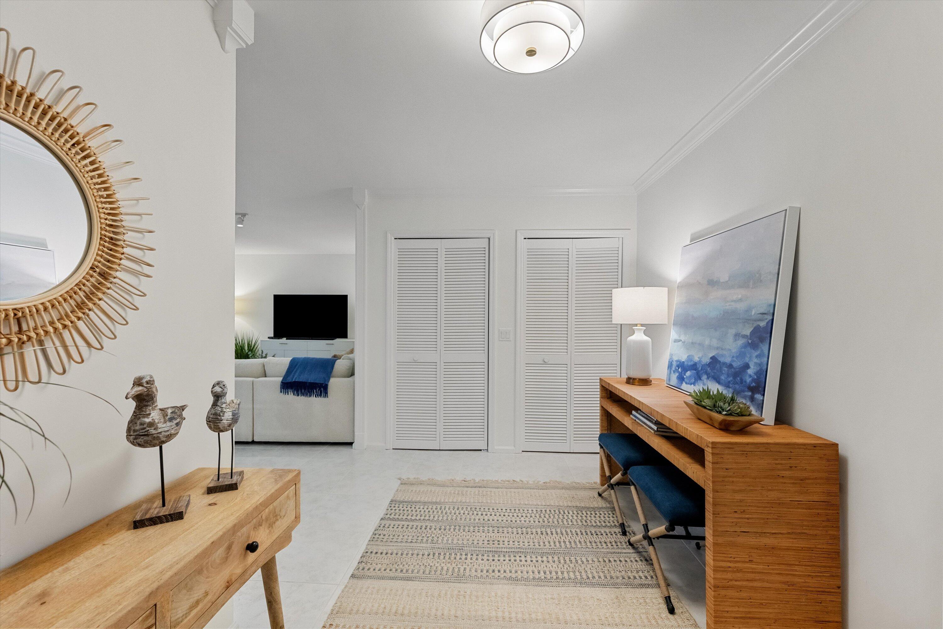 17166 Waterbend Drive, Unit 111 Jupiter, FL 33477 - Photo 5 of 34 a living room with furniture a flat screen tv and a fireplace