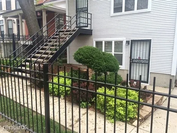 a view of a house with iron fence