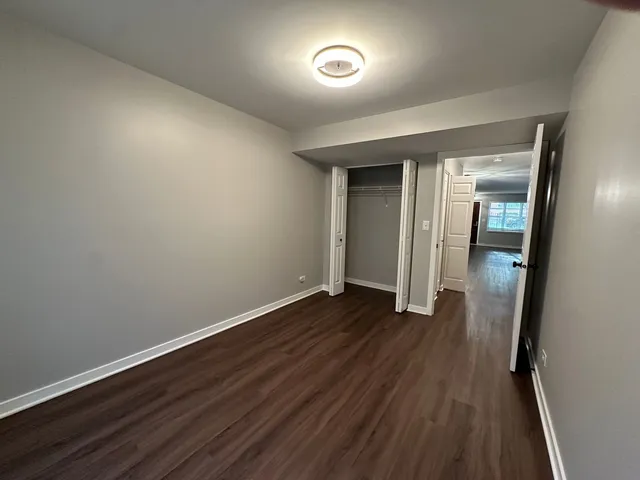 wooden floor in an empty room with a mirror