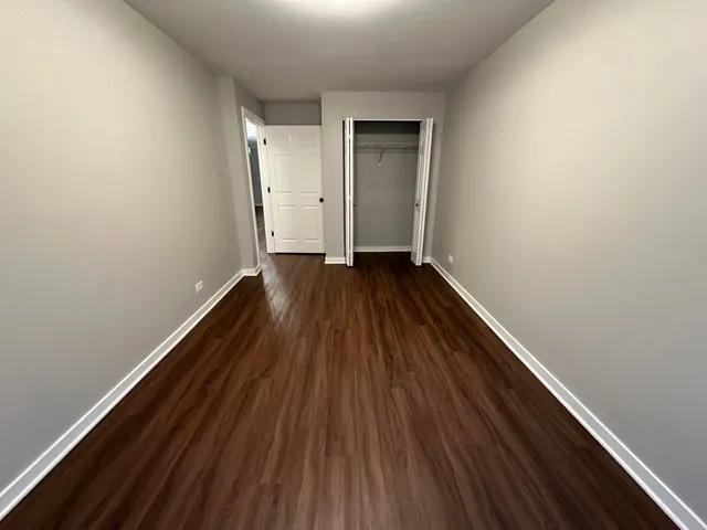 a view of wooden floor in a hallway