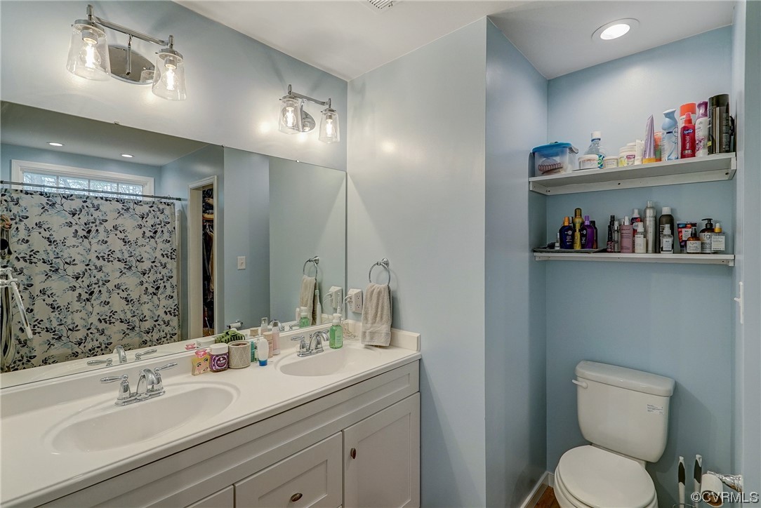 3334 Three Chopt Road Gum Spring, VA 23065 - Photo 31 of 44 a bathroom with a toilet sink and a large mirror