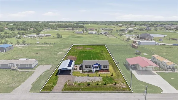 an aerial view of a house with outdoor space