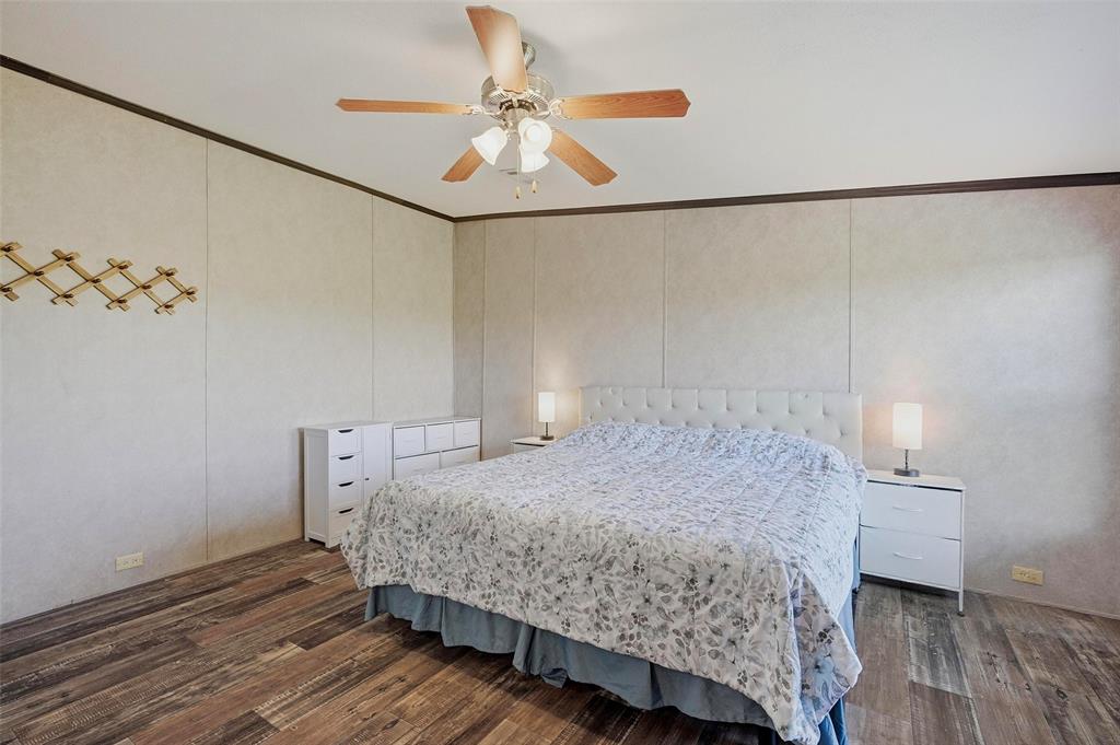 1113 Caroline Court Howe, TX 75459 - Photo 15 of 32 a bedroom with a bed and a chandelier