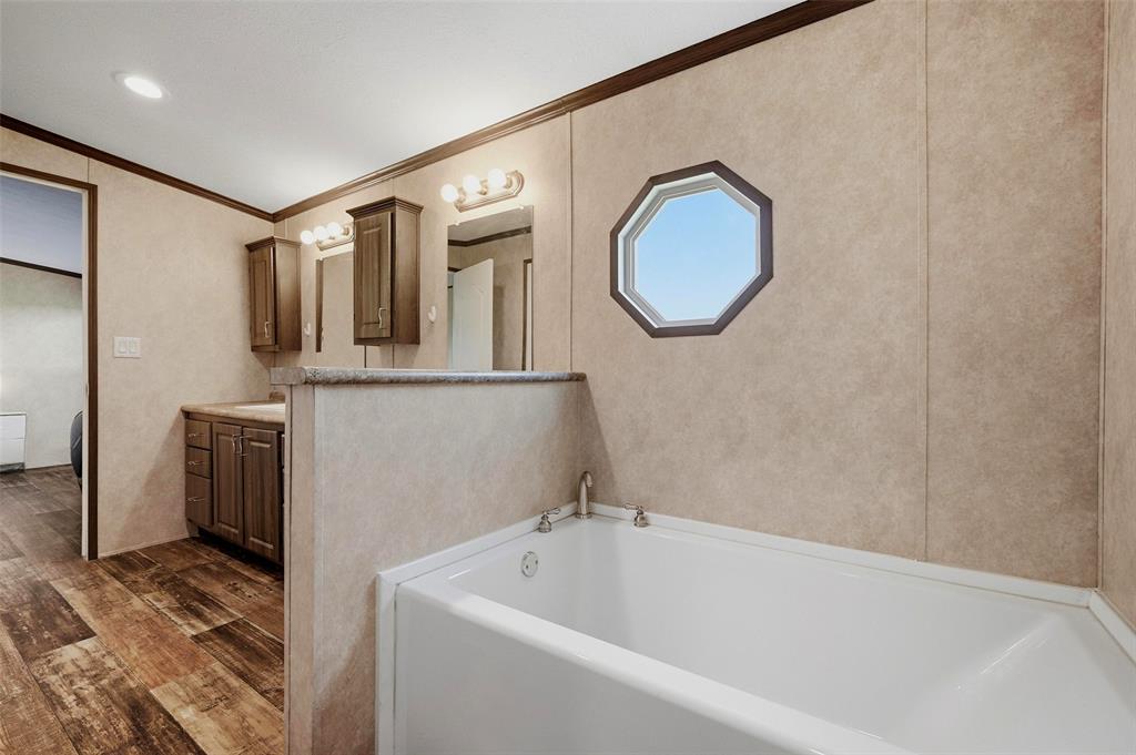 1113 Caroline Court Howe, TX 75459 - Photo 17 of 32 a bathroom with a tub and a mirror
