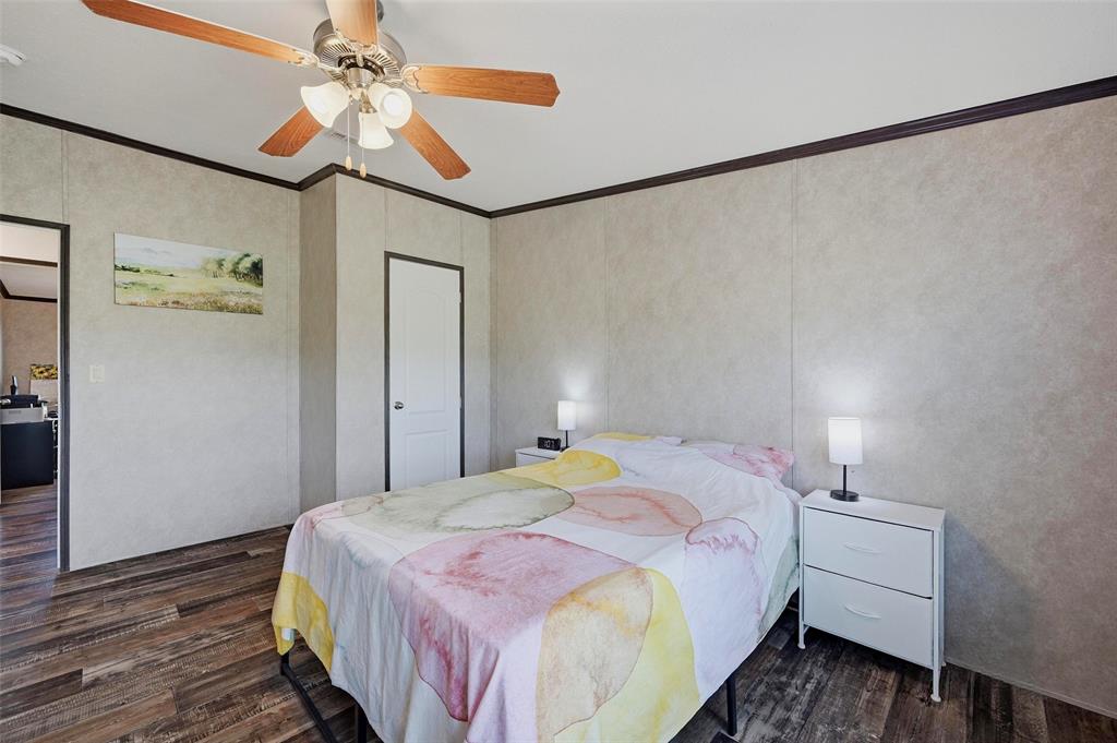 1113 Caroline Court Howe, TX 75459 - Photo 21 of 32 a bedroom with a bed and a chandelier