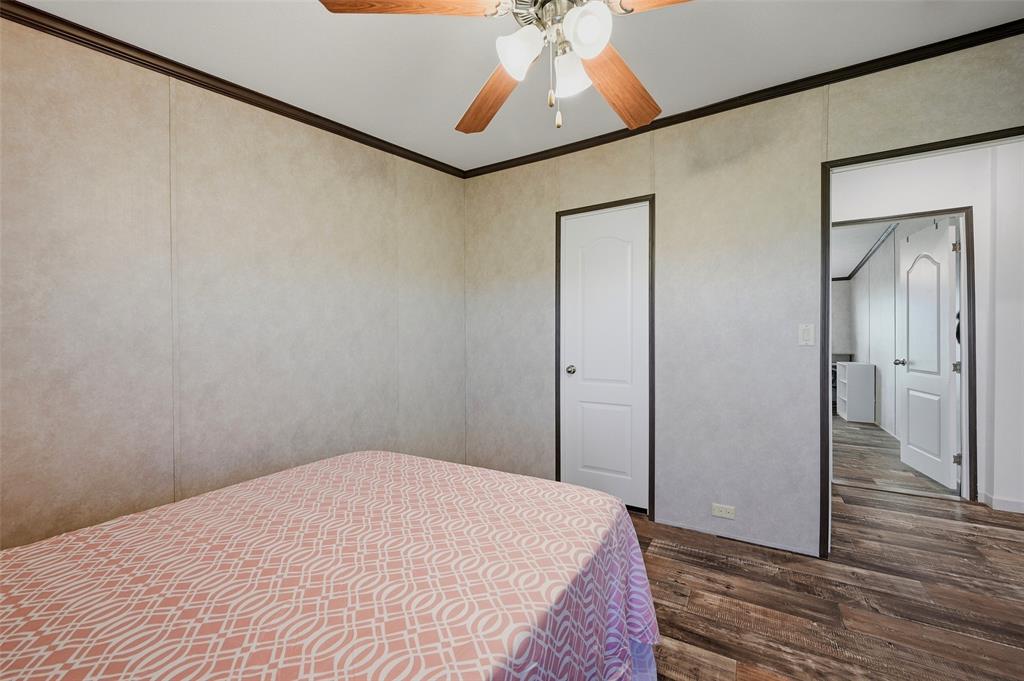 1113 Caroline Court Howe, TX 75459 - Photo 23 of 32 a bedroom with a bed and a chandelier fan