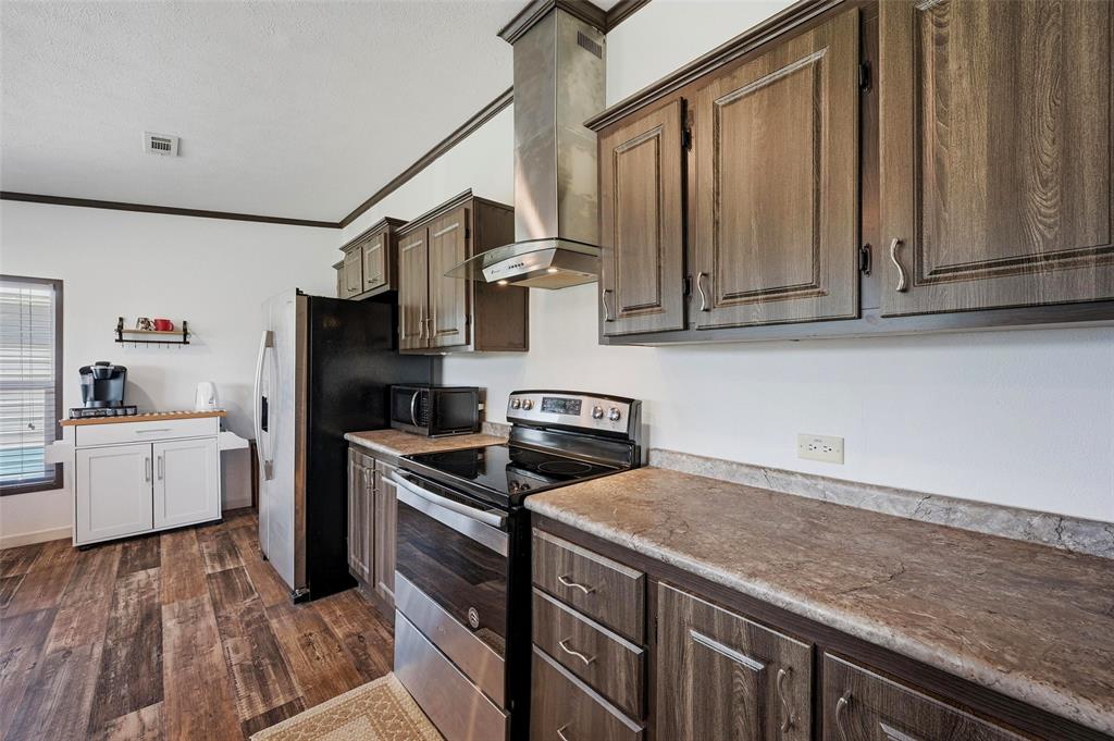 1113 Caroline Court Howe, TX 75459 - Photo 8 of 32 a kitchen with a stove microwave and refrigerator
