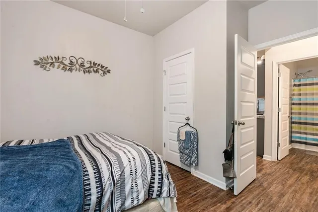 a view of a bedroom with wooden floor