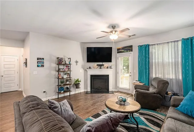 a living room with furniture a fireplace and a flat screen tv