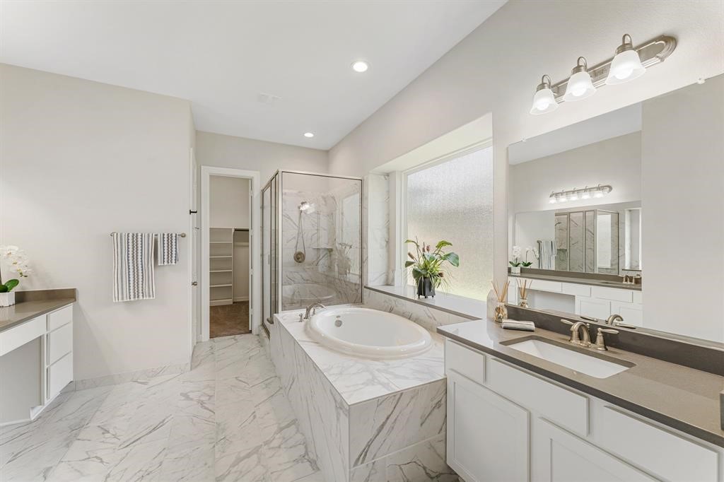 2311 Jitterbug Lane Katy, TX 77493 - Photo 11 of 25 a spacious bathroom with a shower sink and mirror
