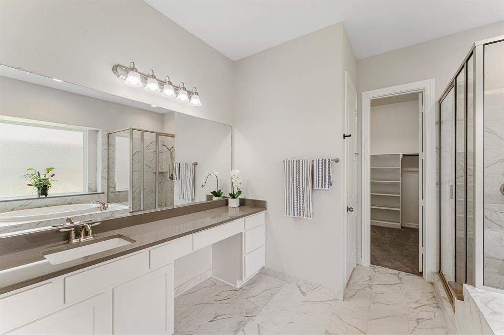 2311 Jitterbug Lane Katy, TX 77493 - Photo 12 of 25 a spacious bathroom with a sink and a mirror