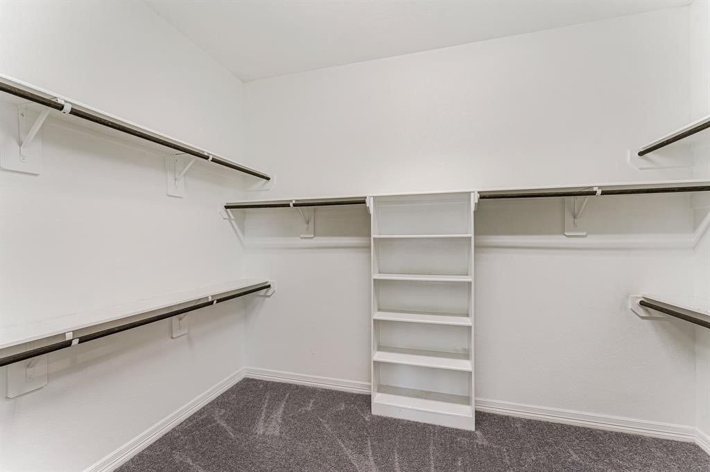 2311 Jitterbug Lane Katy, TX 77493 - Photo 15 of 25 a view of walk in closet with empty racks