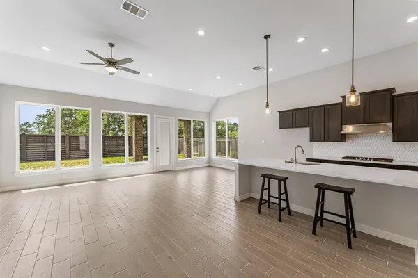 a large kitchen with kitchen island a large island in the center windows and furniture