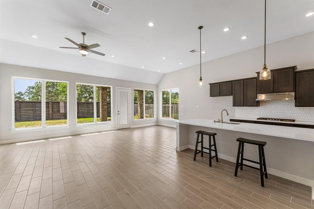 2311 Jitterbug Lane Katy, TX 77493 - Photo 5 of 25 a large kitchen with kitchen island a large island in the center windows and furniture