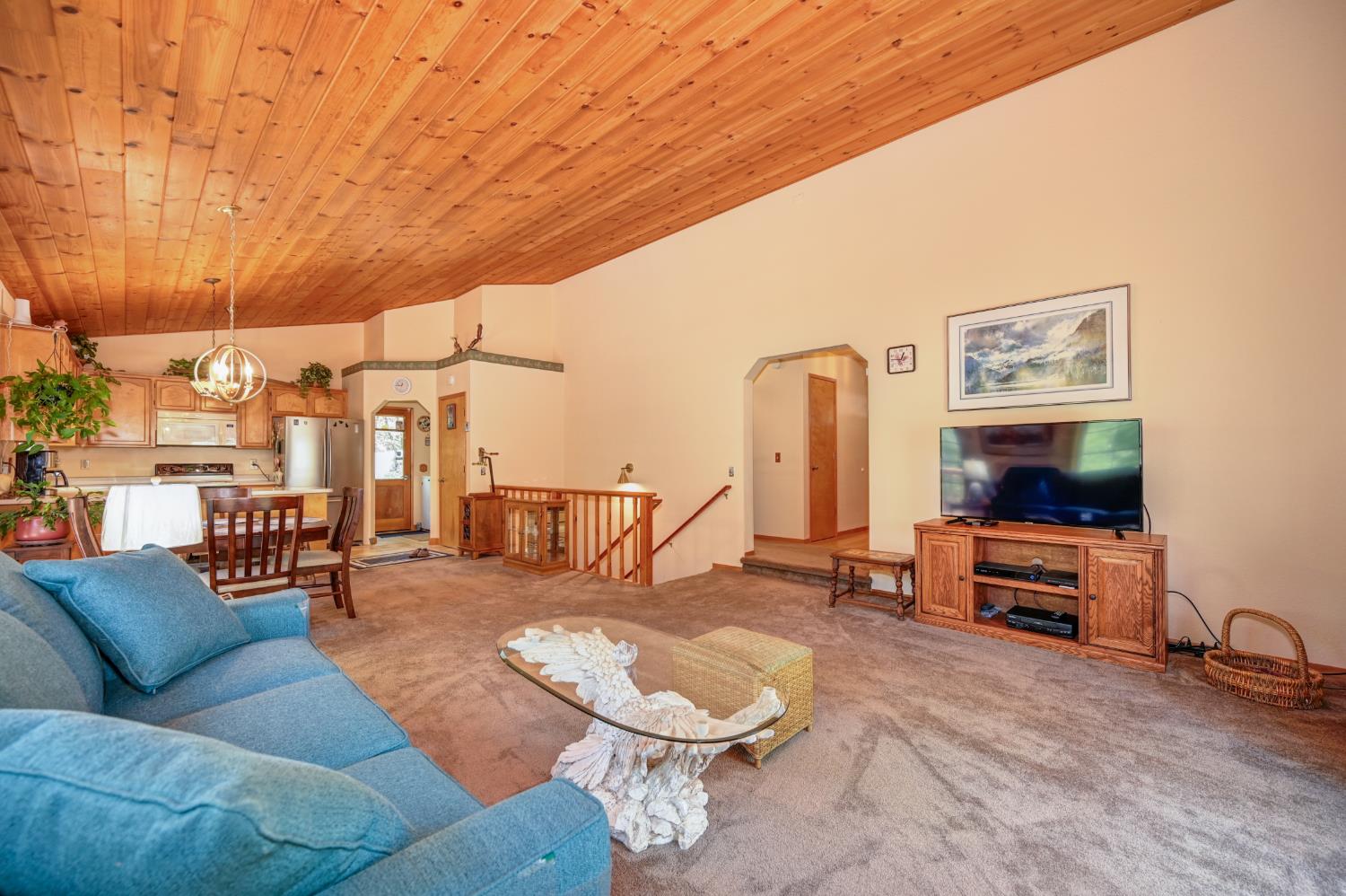 23998 Stable Road Sonora, CA 95370 - Photo 9 of 41 a living room with furniture and a flat screen tv