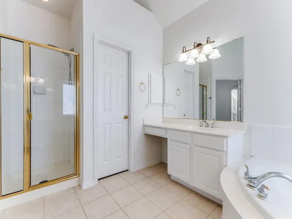 a bathroom with a double vanity sink mirror and shower