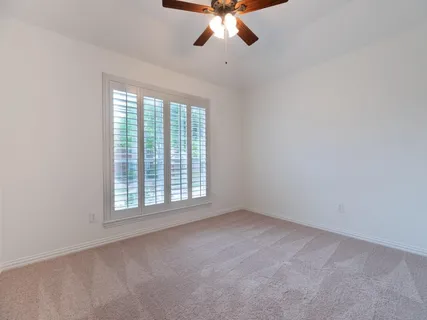 a bedroom with a bed a rug and dresser