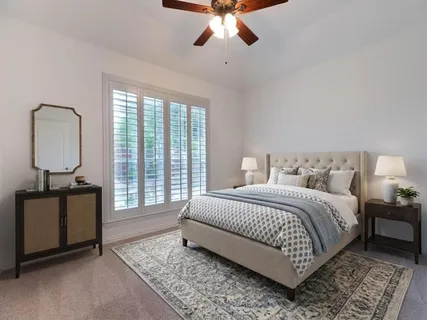 an empty room with closet and windows