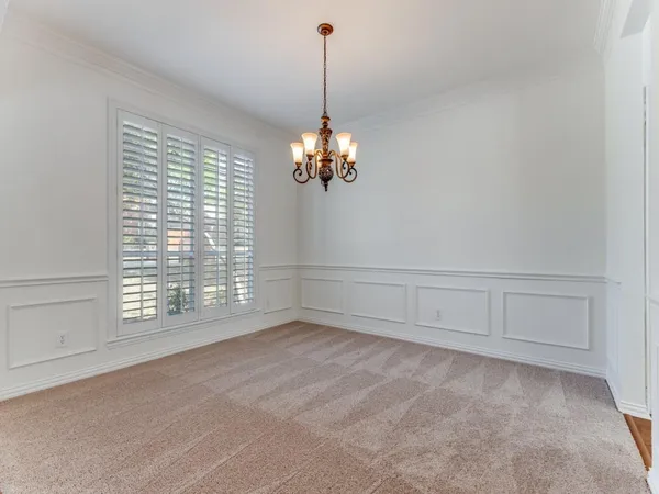 a view of a room with natural light and hardwood floor