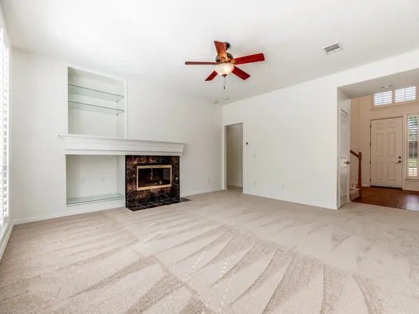 a view of an empty room with a fireplace