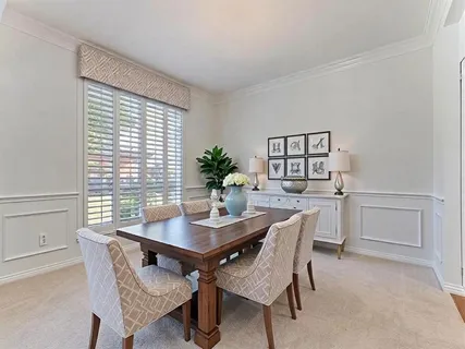 a dining room with furniture and window