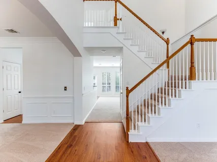 a view of entryway and hall with wooden floor