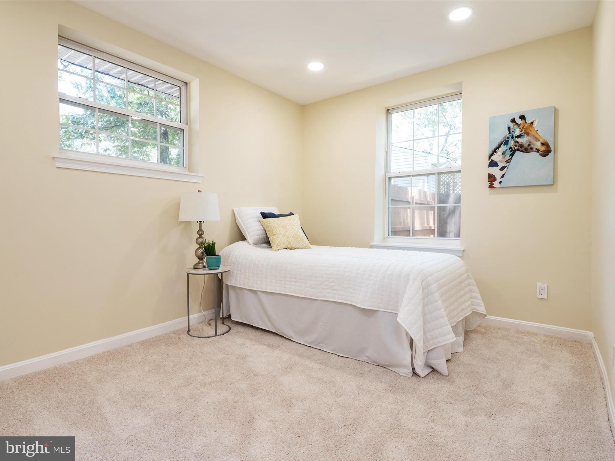 1395 Rainbow Drive Pasadena, MD 21122 - Photo 14 of 28 a bedroom with a bed painting on the wall and a window