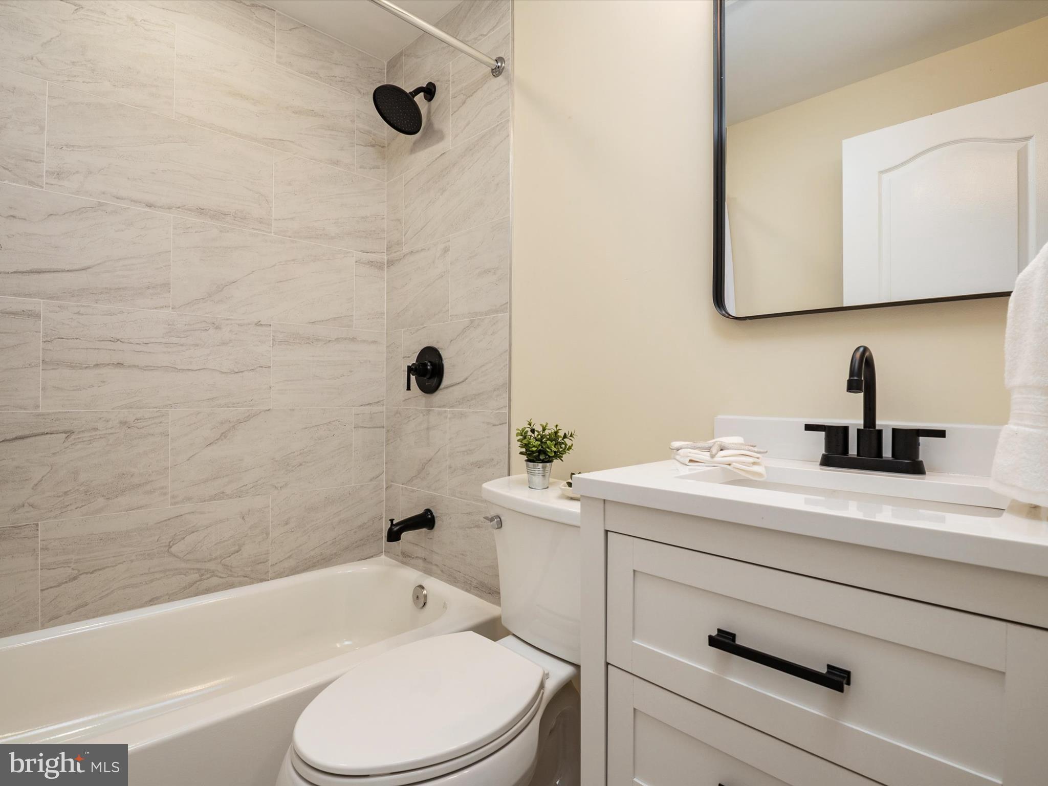 1395 Rainbow Drive Pasadena, MD 21122 - Photo 16 of 28 a bathroom with a sink a toilet and a bathtub
