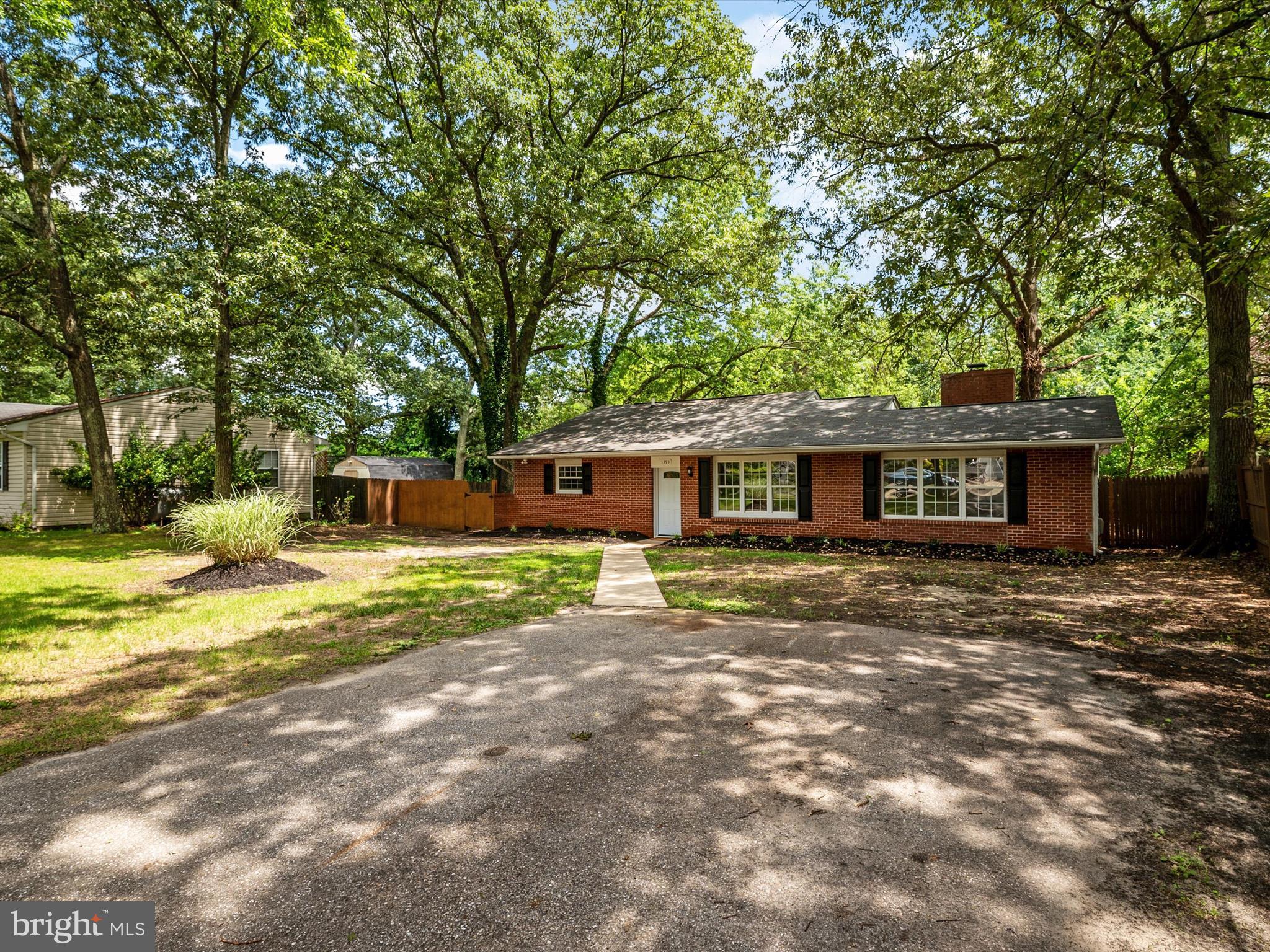 1395 Rainbow Drive Pasadena, MD 21122 - Photo 2 of 28 a front view of a house with a garden