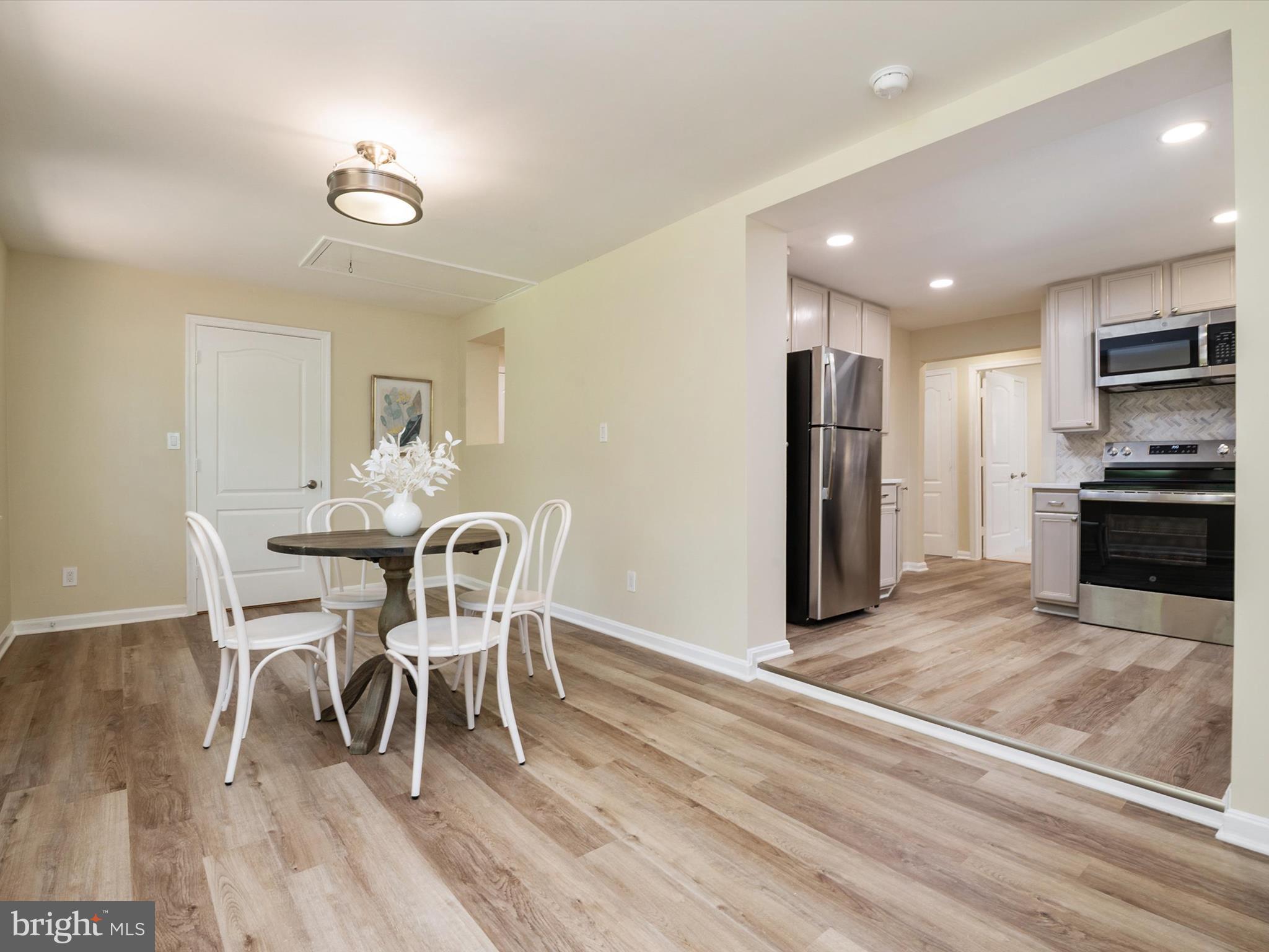 1395 Rainbow Drive Pasadena, MD 21122 - Photo 21 of 28 a view of a dining room with furniture and wooden floor