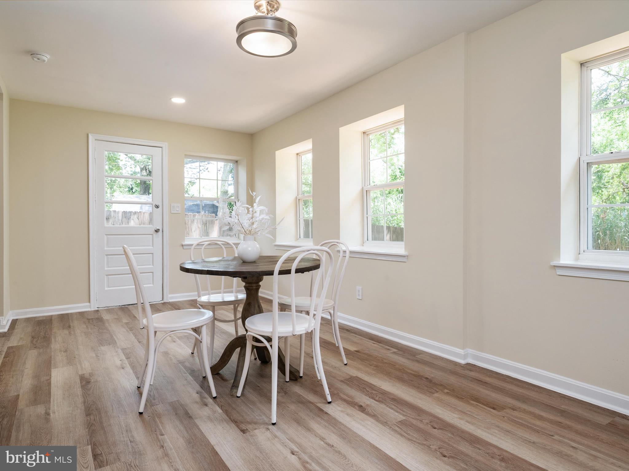 1395 Rainbow Drive Pasadena, MD 21122 - Photo 23 of 28 a view of a dining room with furniture and wooden floor