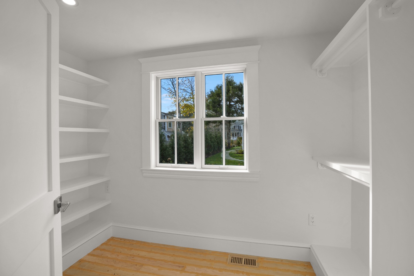 23 Pinehurst Road Edgartown, MA 02539 - Photo 56 of 57 a view of an empty room with wooden floor and windows