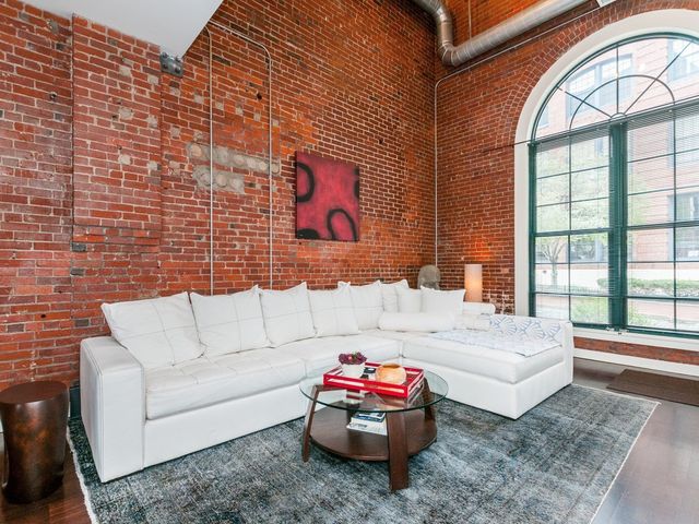 a living room with furniture and a floor to ceiling window