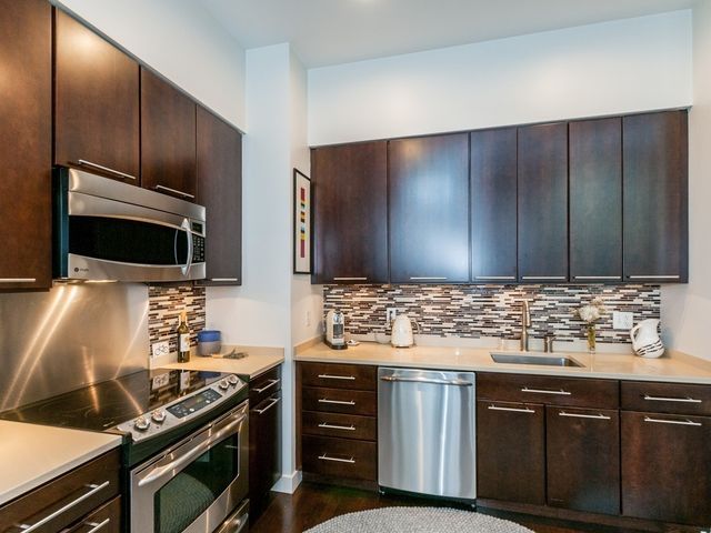 a kitchen with wooden cabinets and a stove top oven