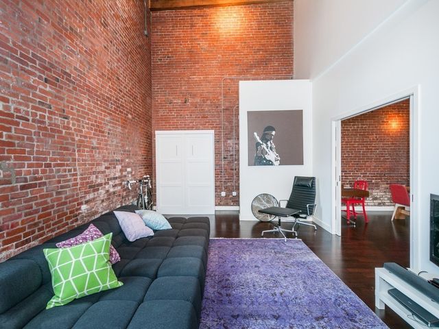 a living room with furniture rug and wooden floor