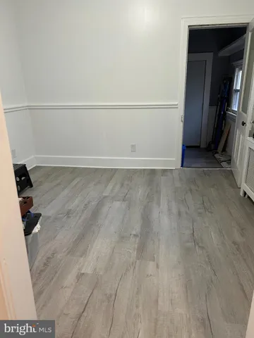 a view of a closet with wooden floor
