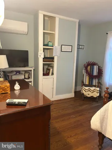 a view of a room with wooden floor and furniture
