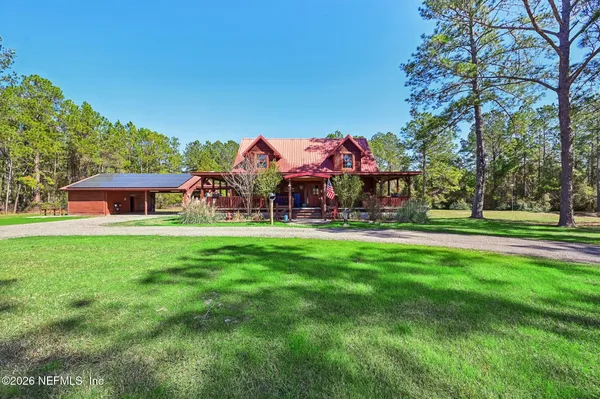 a front view of house with yard and green space