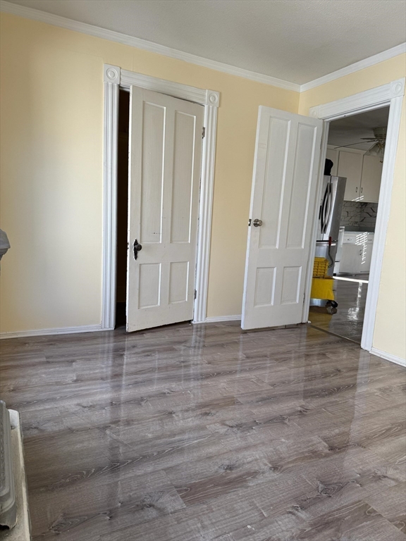 360 School Street, Unit 2 Webster, MA 01570 - Photo 17 of 21 a view of a room with wooden floor and a cabinet