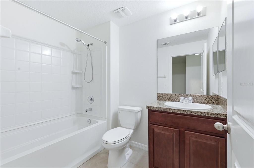 12909 Dream Catcher Way Riverview, FL 33579 - Photo 23 of 32 a bathroom with a granite countertop sink toilet and shower