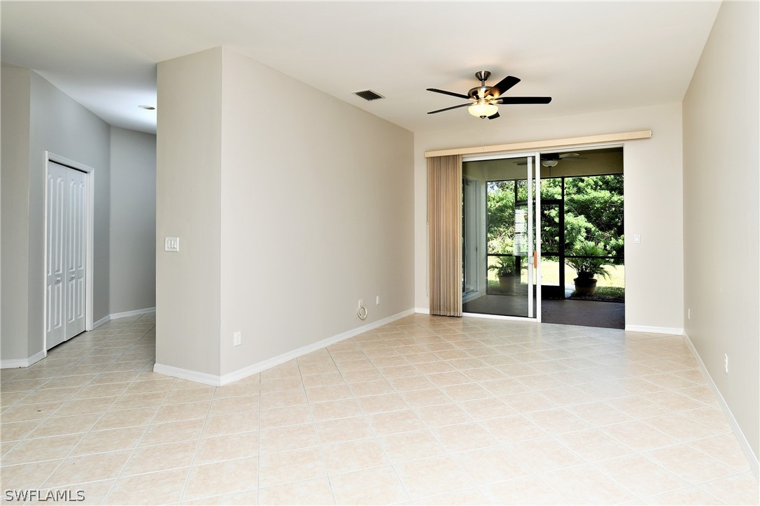 4612 Fairloop Run Lehigh Acres, FL 33973 - Photo 12 of 35 a view of a livingroom with wooden floor and a ceiling fan