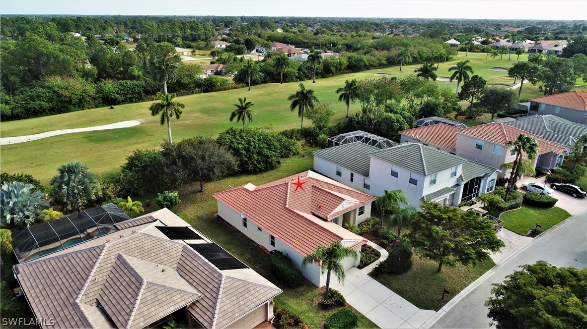 4612 Fairloop Run Lehigh Acres, FL 33973 - Photo 15 of 35 an aerial view of a house swimming pool patio and lake view