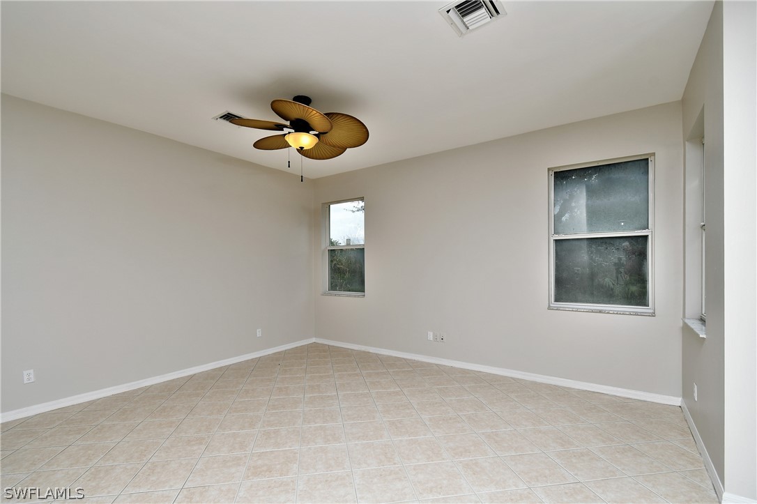 4612 Fairloop Run Lehigh Acres, FL 33973 - Photo 19 of 35 an empty room with windows and fan
